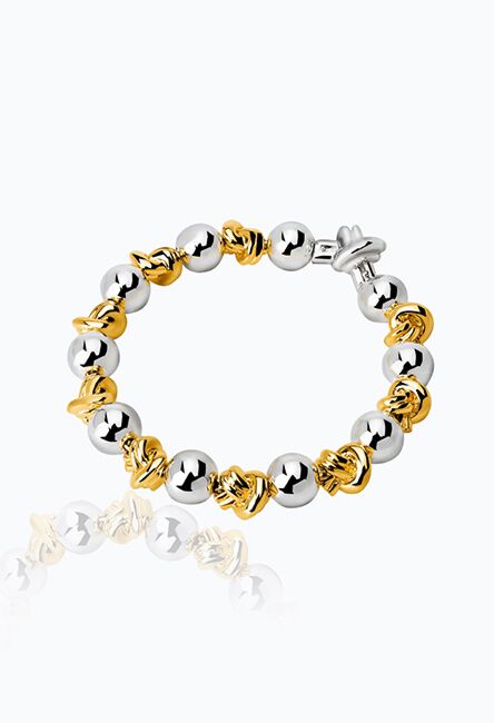 pulsera de esferas doradas y nudos dorados
