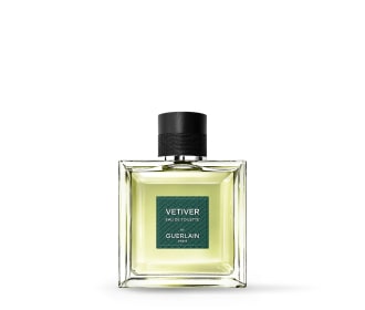 botella de perfume verda con etiqueta verde y tapa negra, guerlain