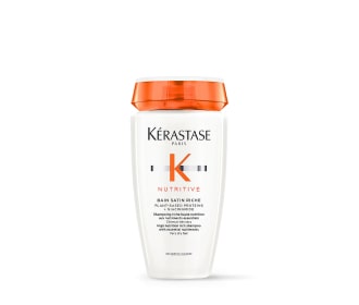 imagen de botella blanca con tapa naranja de shampoo, kerastase