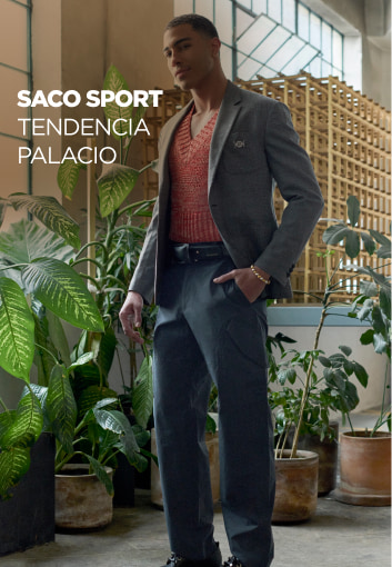 Hombre usando sueter marron y traje color gris