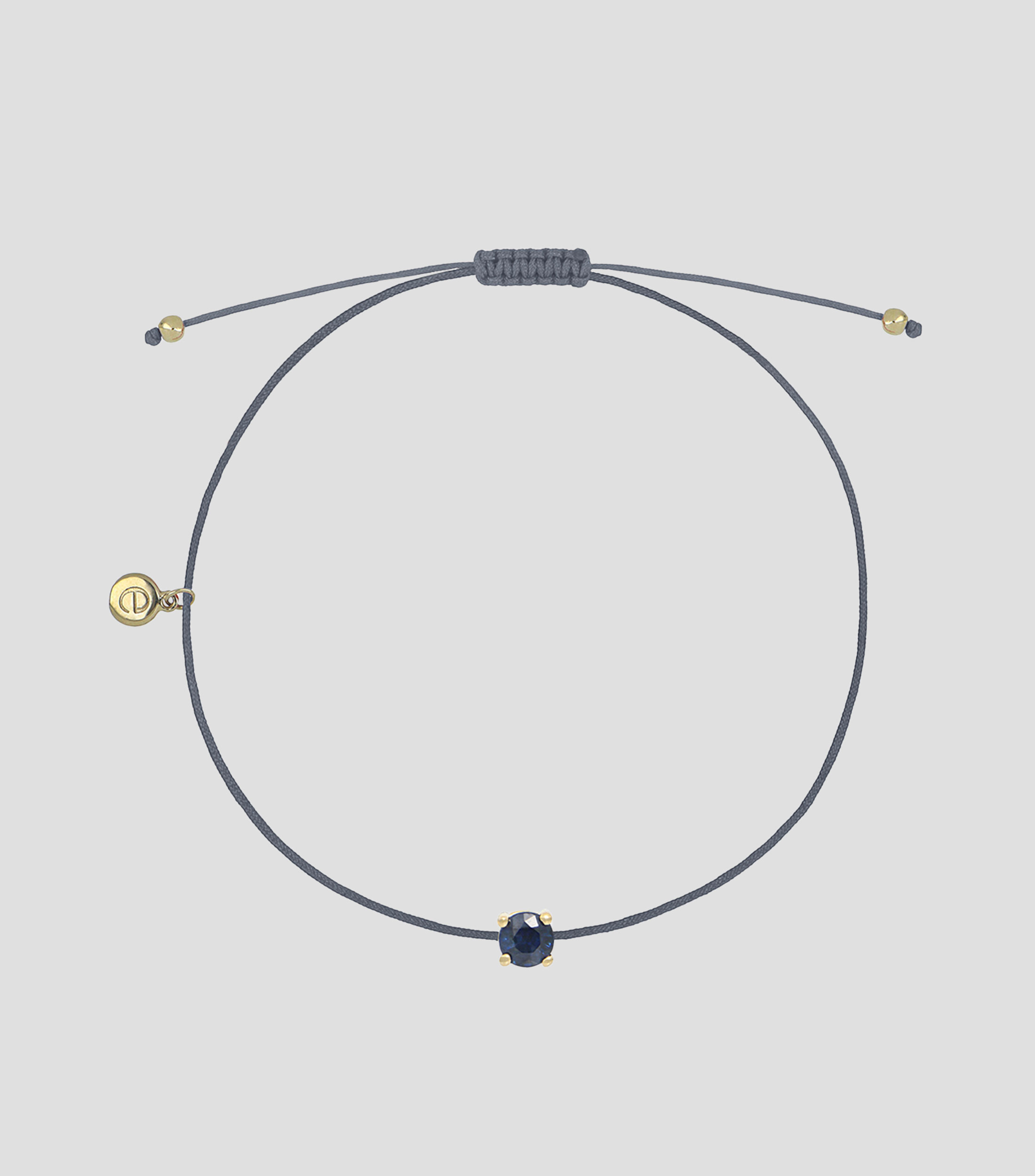 Pulsera en hilo gris con dije zafiro Mujer