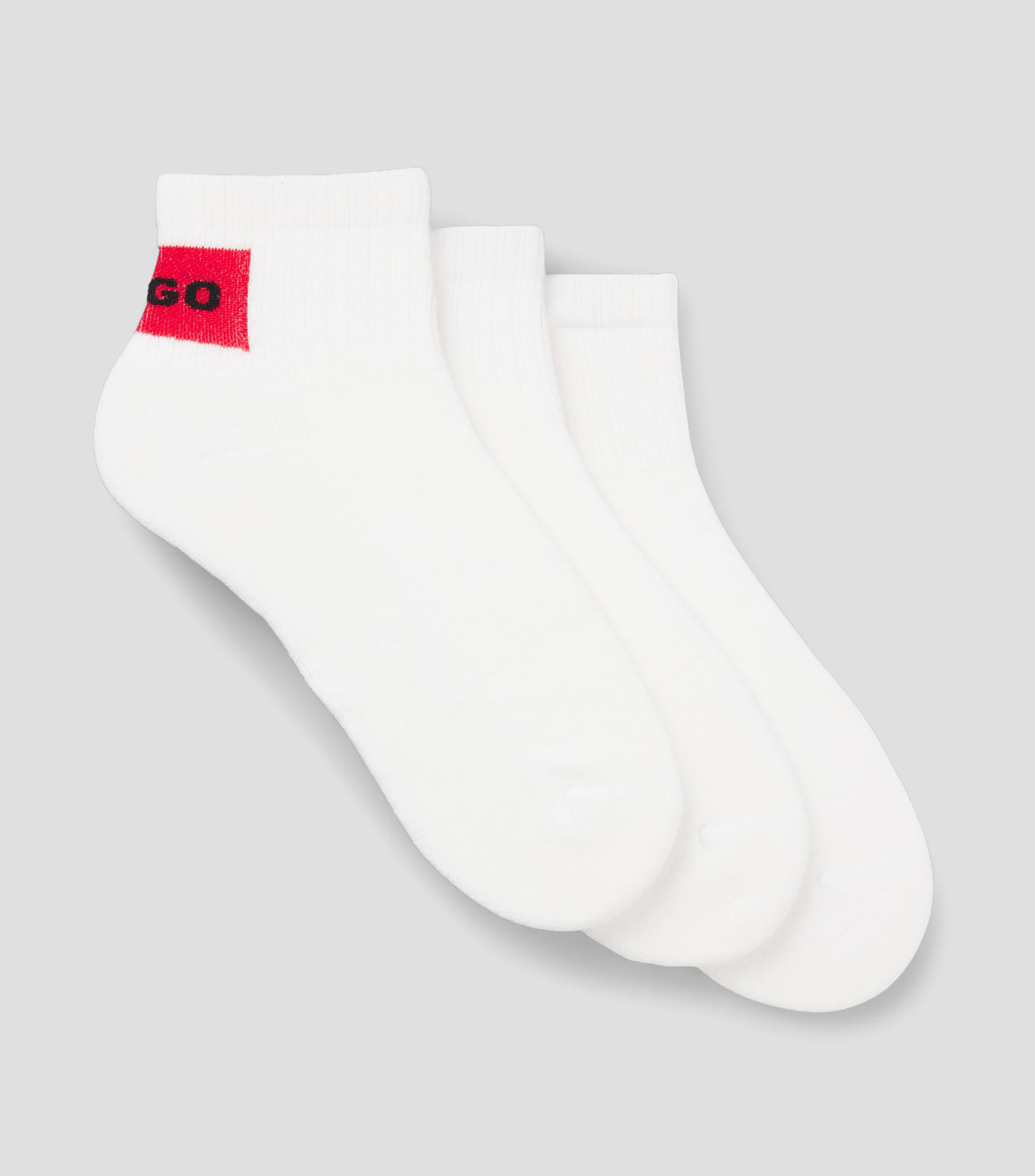 Paquete de tres pares de calcetines tobilleros con etiquetas con logo rojas Hombre