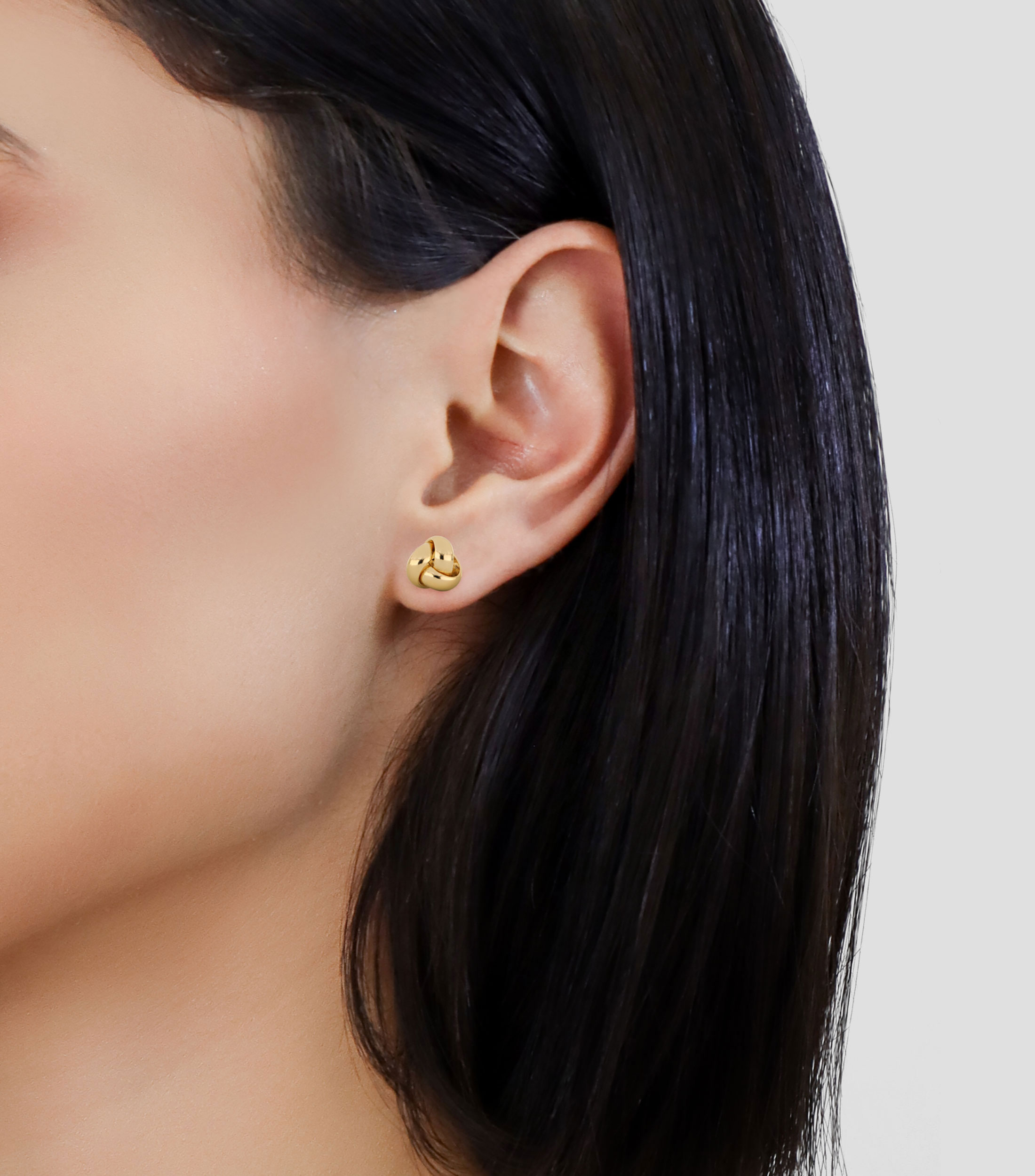 Aretes en oro de 14 kilates en forma de nudo Mujer