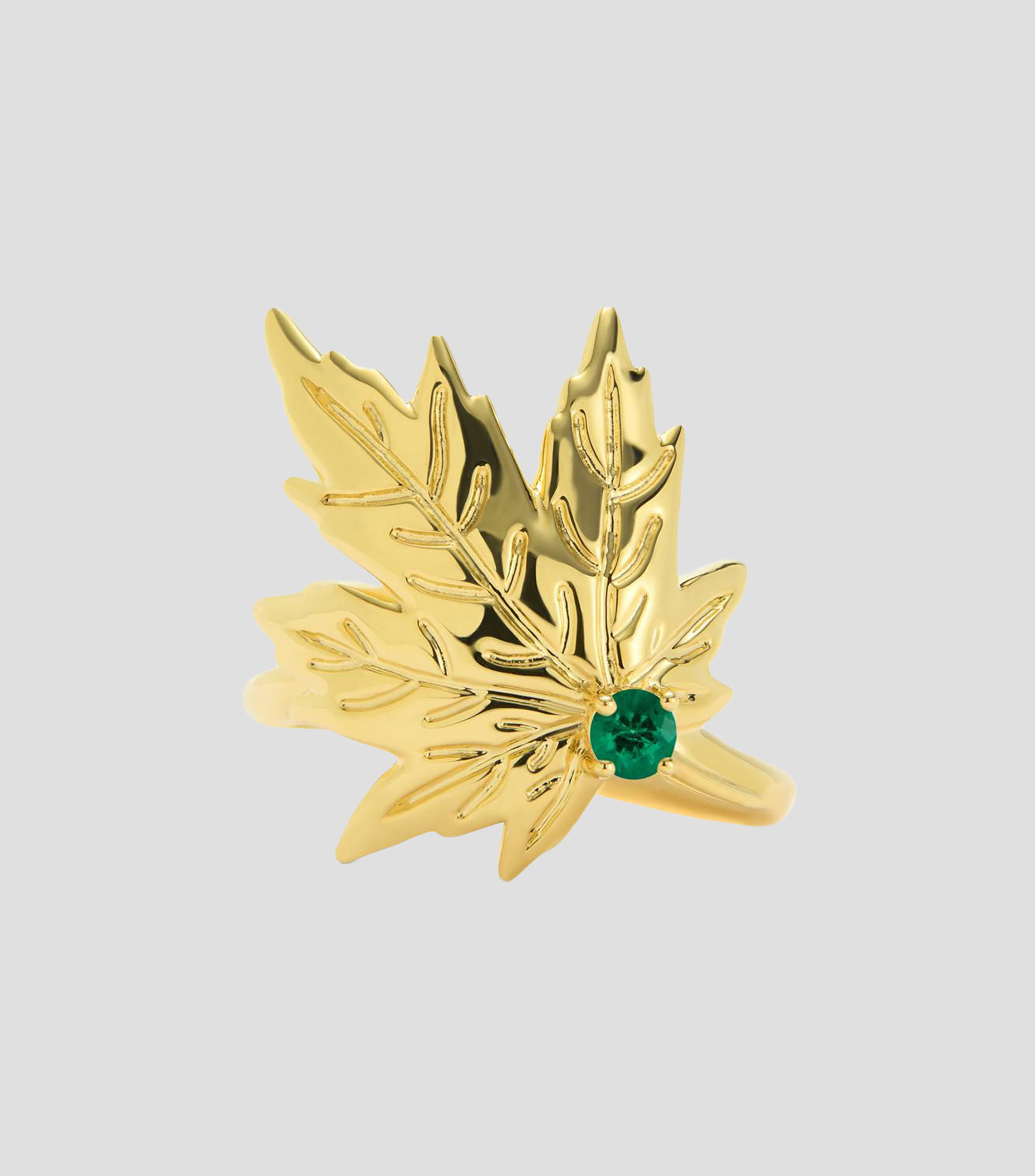 Anillo en Oro amarillo de 18 Kilates con esmeralda central en talla brillante y forma en hoja de arce Mujer
