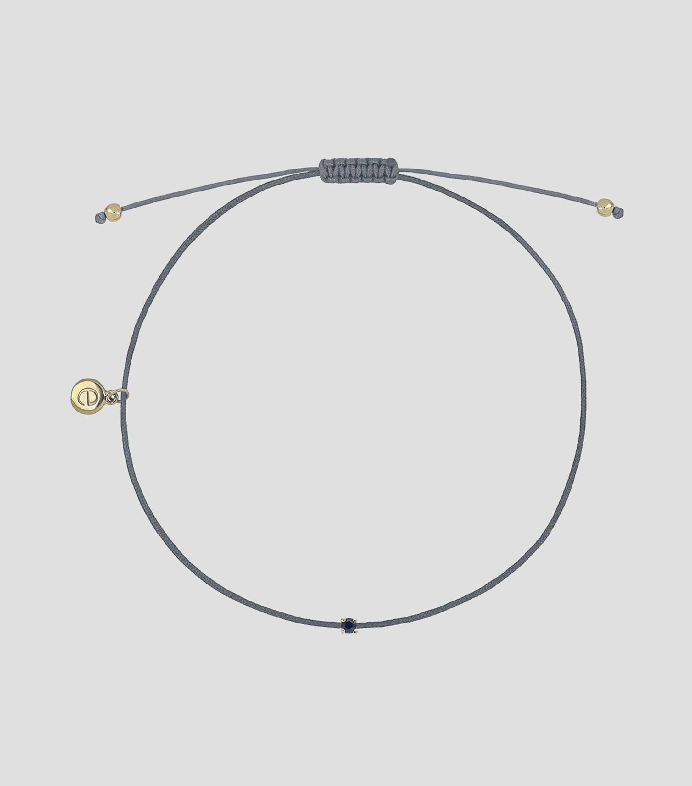 Pulsera de hilo gris con dije de zafiro Mujer