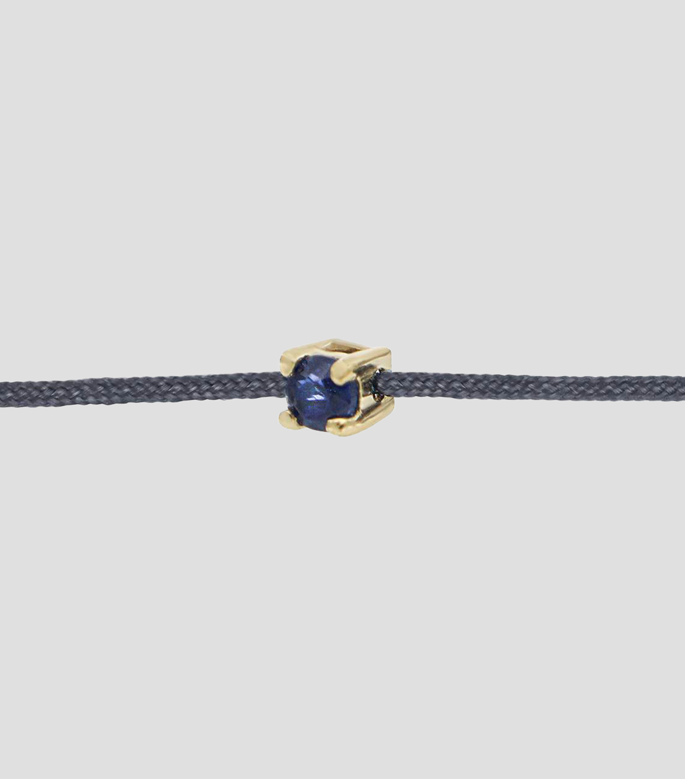 Pulsera de hilo gris con dije de zafiro Mujer