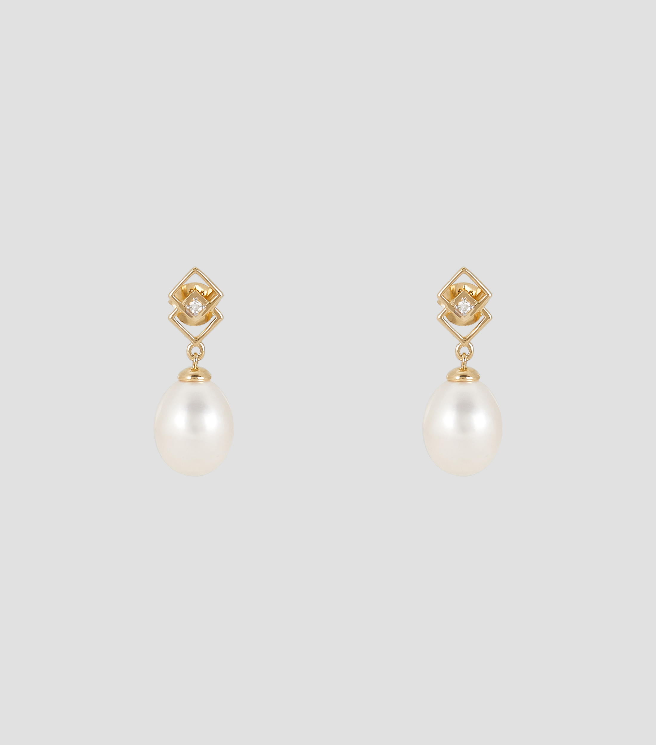 Aretes en oro amarillo de 14 kilates con perlas Mujer