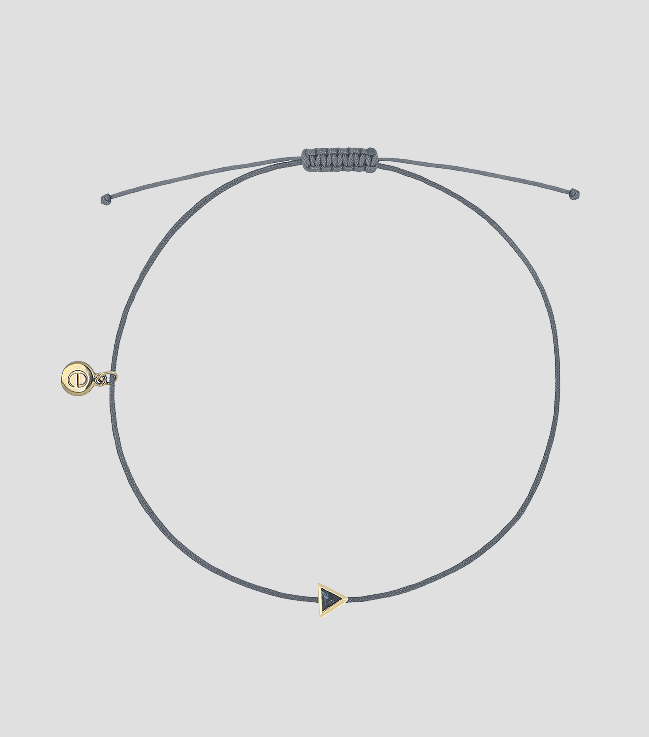 Pulsera gris con zafiro con dije en oro amarillo de 18 kilates Mujer