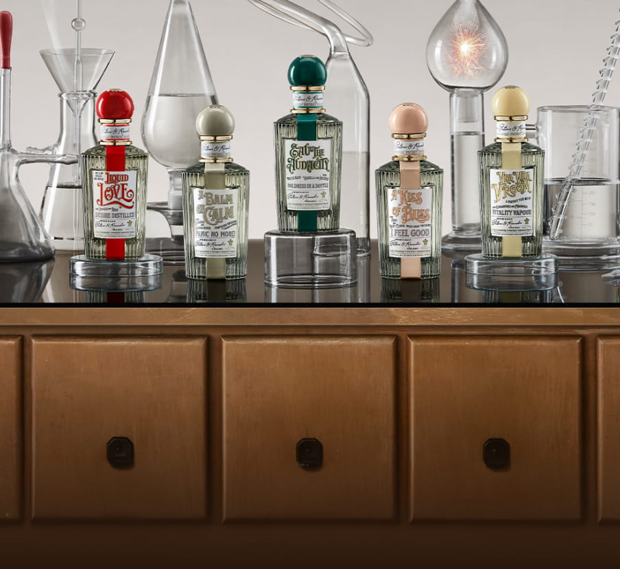 Imagen de 5 botellas de locion de tapas redondas roja, gris, verde, rosa y amarilla. PENHALIGON'S