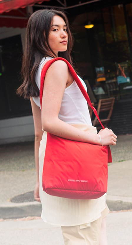 imagen de mujer con vestido blanco y bolso rojo