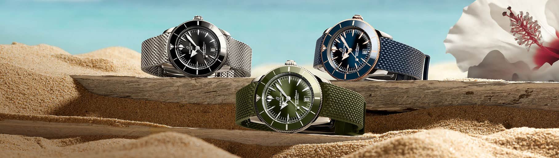 imagen de 3 relojes uno plata, uno azul y uno verde de la marca BREITLING