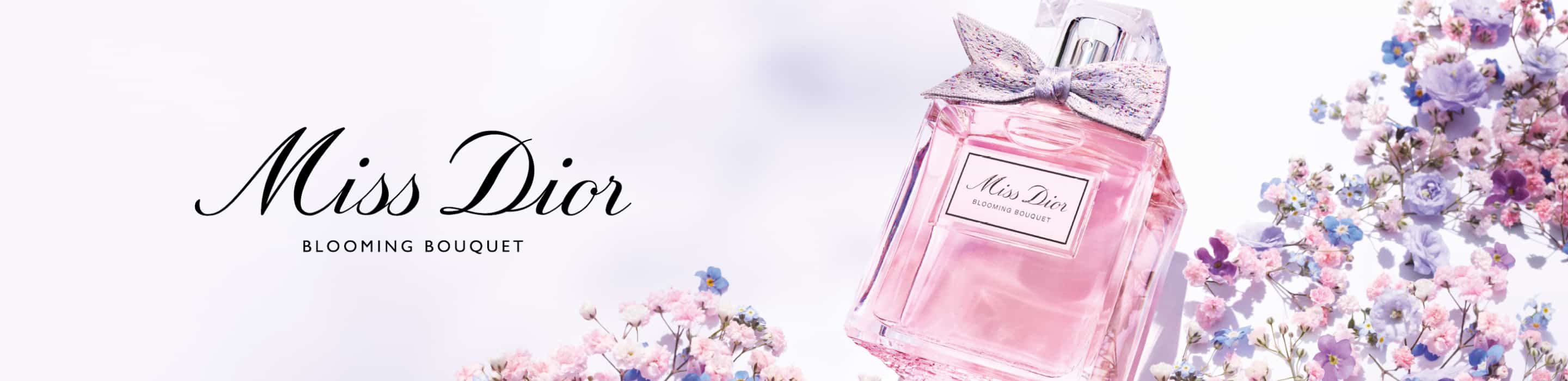 Imagen de botella de perfume rosa con un moño MIS DIOR. DIOR