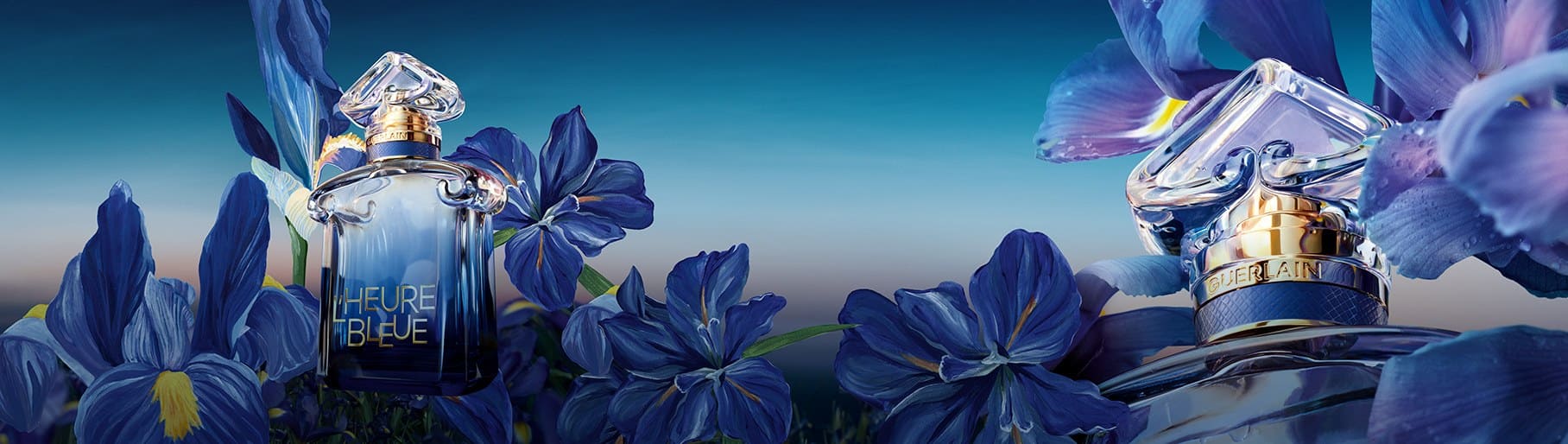 imagen de una frasco de perfume color azul de la marca GUERLAIN, entre flores azules 