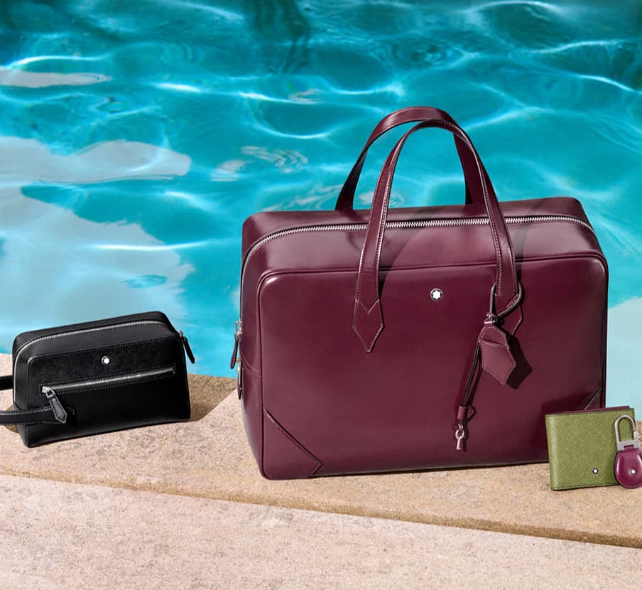 Imagen de una mini bag, portafolio, crtera y un llavero todos articulos de piel, MONTBLANC
