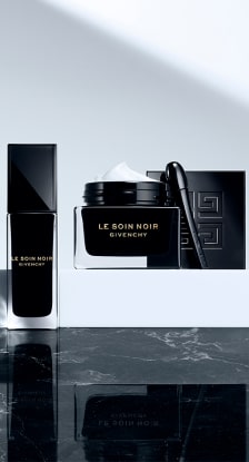 Imagen de una crema y un perfumes de frasco negro de la marca GIVENCHY. GIVENCHY