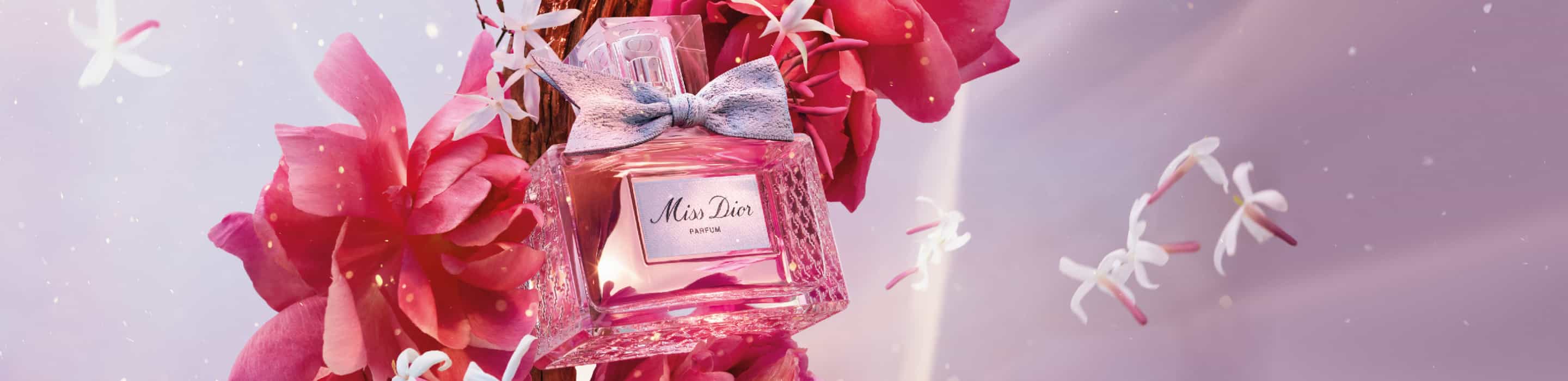 Imagen de botella de perfume rosa con un moño MIS DIOR. DIOR