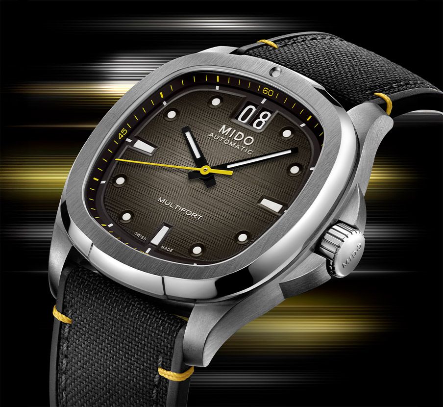 imagen de un reloj color gris con extensible color negro y caratula negra, MIDO