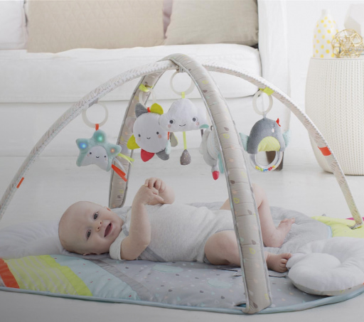 imagen de un bebe acostado con un movil gris