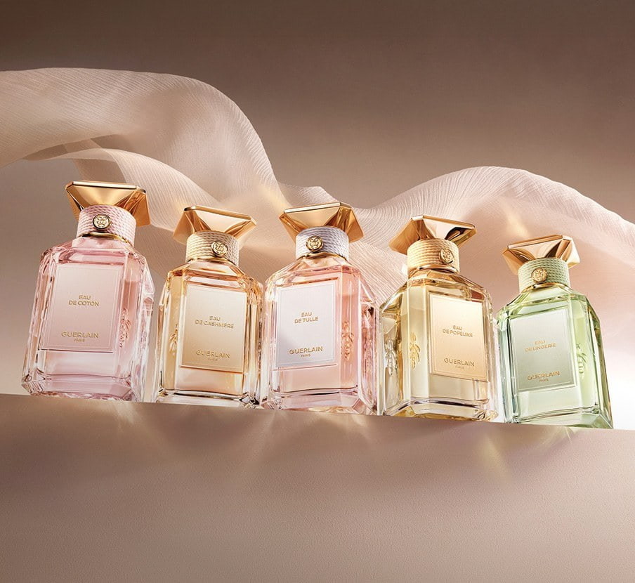 imagen de botellas de distintos colores de la marca GUERLAIN