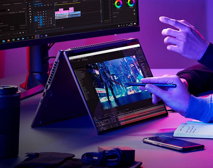 imagen de un monitor y una laptop color negra de la marca ASUS, en la cual se ve que estan diseñando un videojuego. ASUS