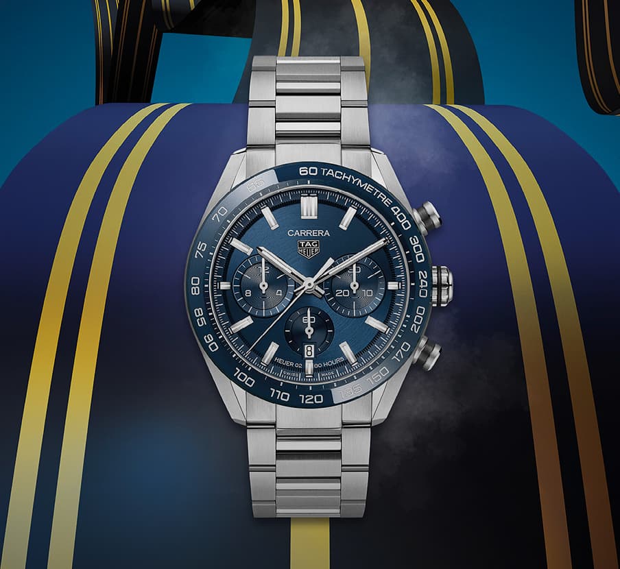 Imagen de reloj color plateado con caratula azul, de fonso lo que parece una psita de carreras. TAG HEUER