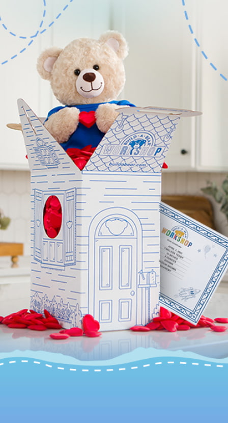imagen de oso de peluche en caja de carton blanca con azul BUILD BEAR
